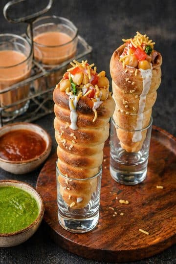 Crispy Chatpati Cone Chaat filled with potatoes, chickpeas, yogurt, chutneys, onions, tomatoes, and sev
