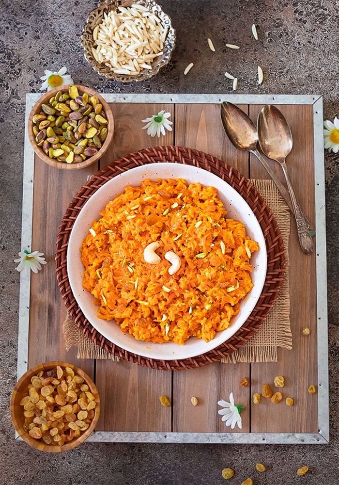 Gajar ka halwa on a tray with spoons