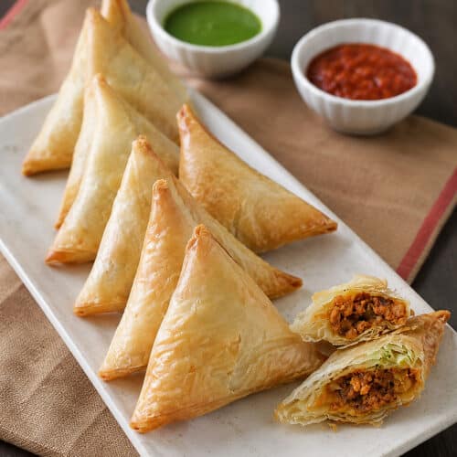 Close-up of flaky Keema Samosa showing savory minced meat filling inside.