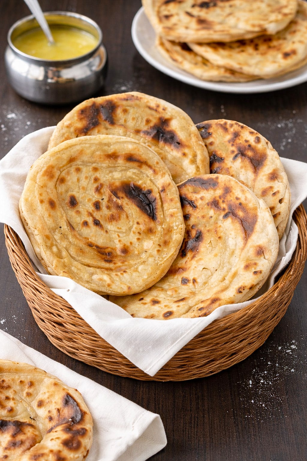 Rustic Indian tandoori roti without oven in a basket with melted ghee