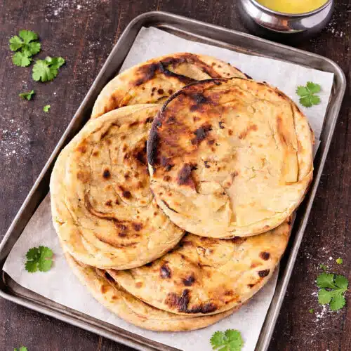 Stovetop tandoori roti recipe with charred texture and cilantro garnish