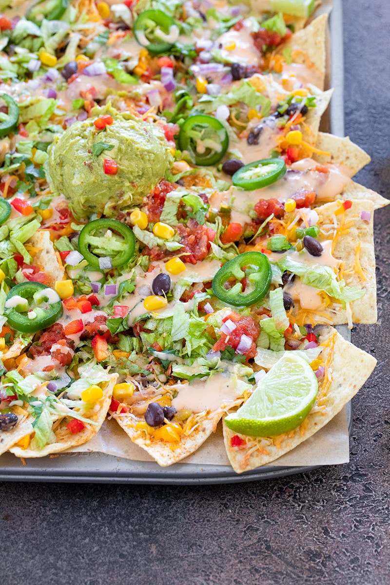 Loaded vegetable Nachos on a sheet pan