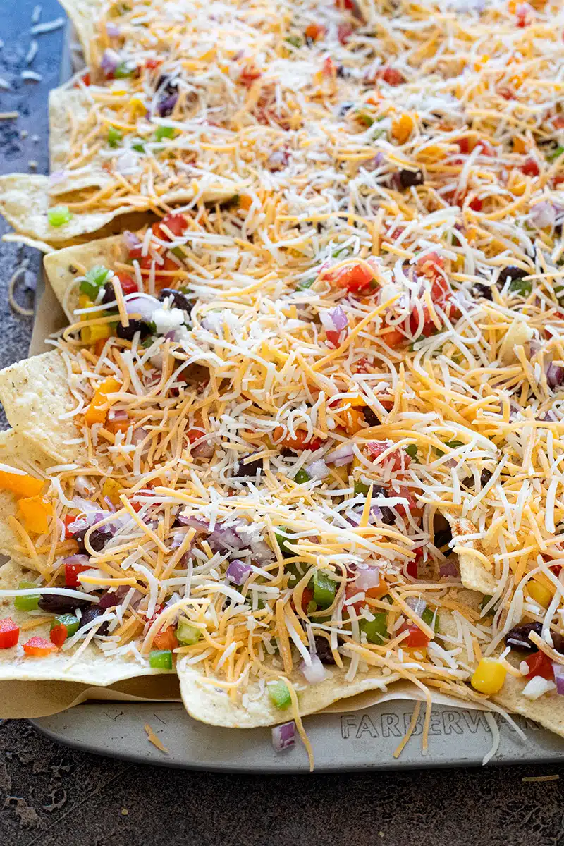 Nachos on a sheet pan ready to be baked