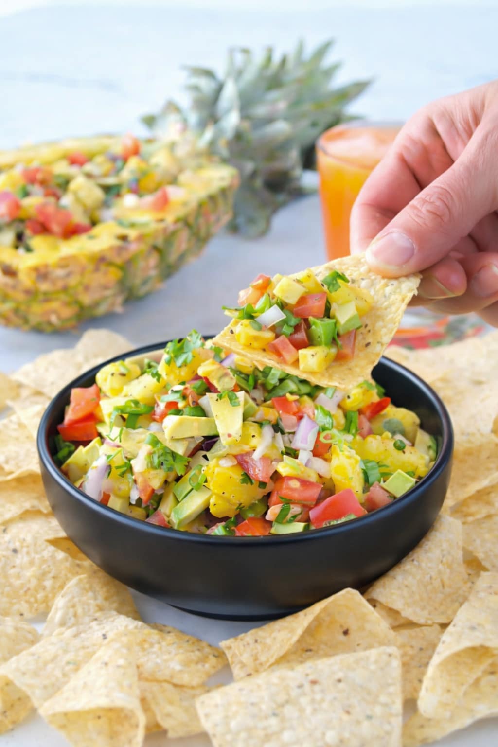 Homemade pineapple salsa with avocado, tomatoes, onion, and cilantro