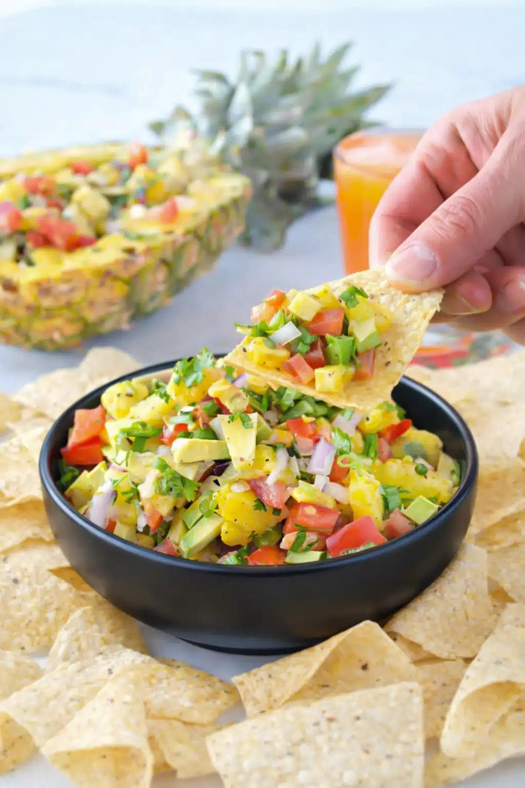 Homemade pineapple salsa with avocado, tomatoes, onion, and cilantro