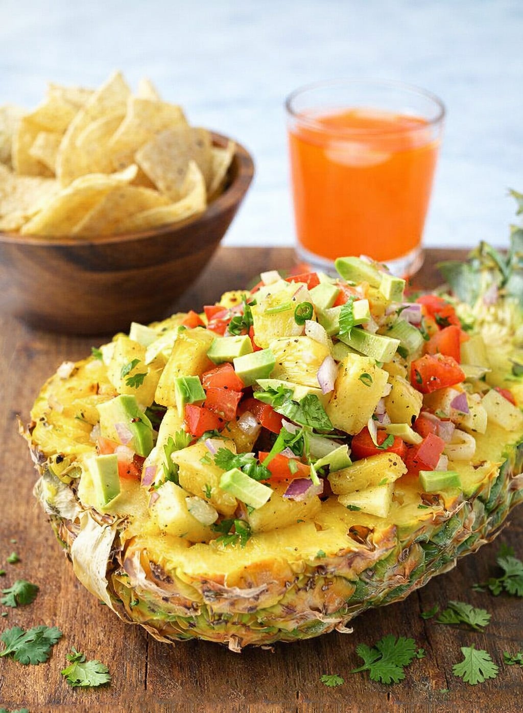 Pineapple salsa appetizer served with tortilla chips and fresh herbs