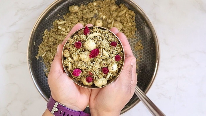 Dhaniya Panjiri in a bowl garnished with rose petals
