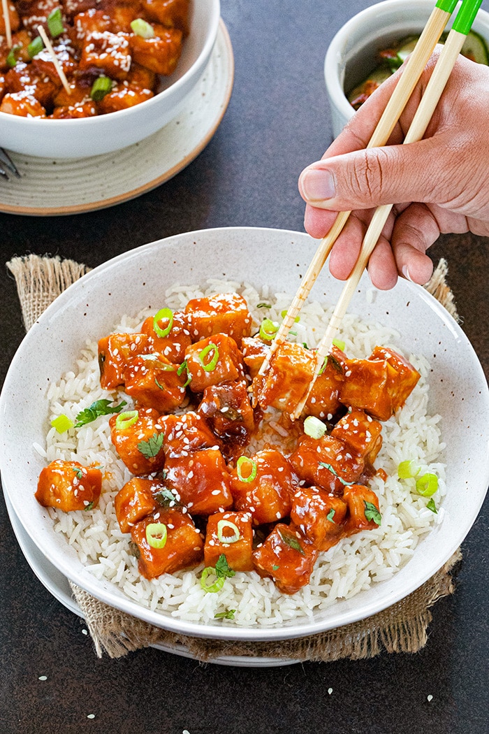 Stir-fried Sweet chili tofu garnished with scallions