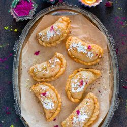 Gujiyas arranged in a tray