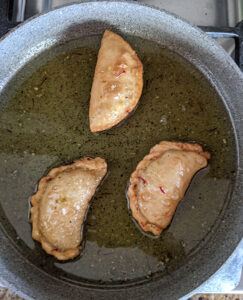 Soak gujiyas in sugar syrup