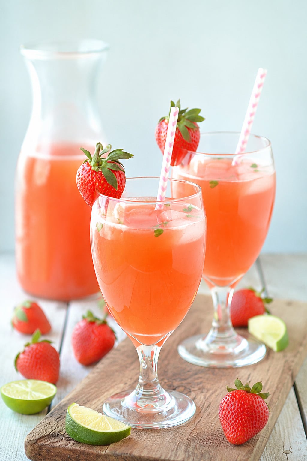 Sparkling strawberry mint lemonade mocktail with fresh berries and lemon slices
