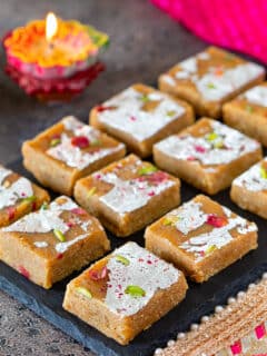 Squares of moong dal burfi arranged on a tray