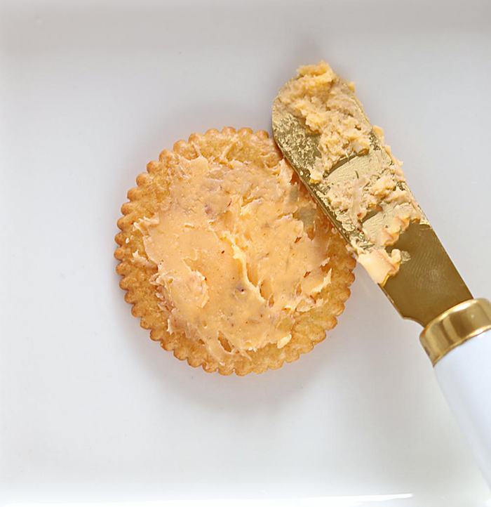 Top ritz cracker with hummus
