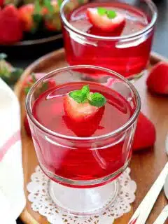Vegan Strawberry Jelly set in serving cups garnished with mint leaves
