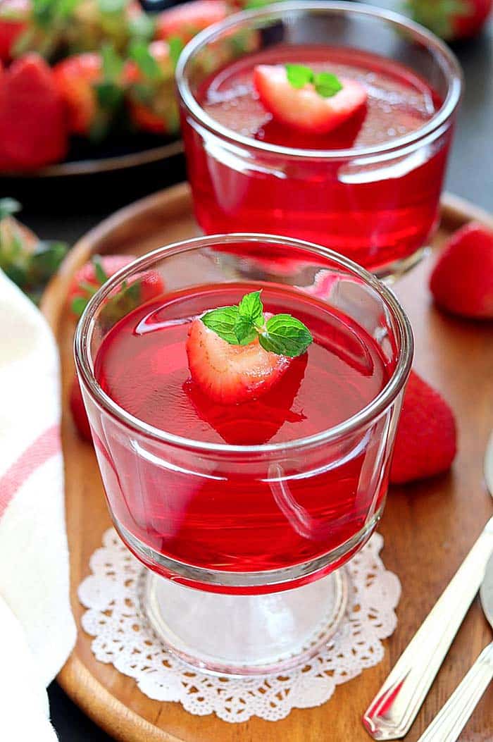 Vegan Strawberry Jelly set in serving cups garnished with mint leaves