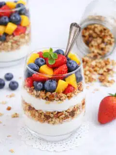 Berry parfait layered with vanilla yogurt, fresh strawberries, blueberries, mango, and crunchy granola