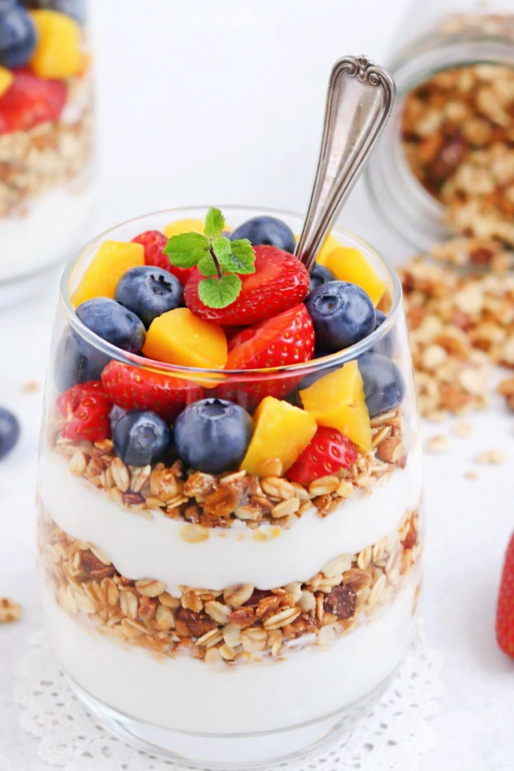 Easy breakfast made with yogurt, blueberries, strawberries, mango, and granola