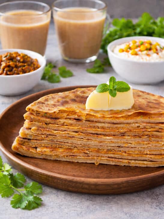 Crispy stuffed onion besan paratha on a plate