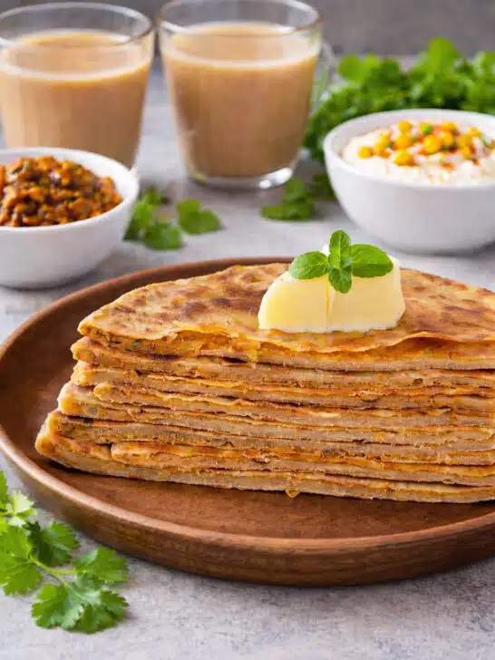 Crispy stuffed onion besan paratha on a plate