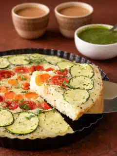 Vegetable semolina quiche with zucchini, tomatoes, carrots, and onions