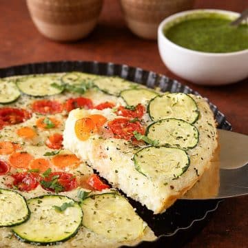 Vegetable semolina quiche with zucchini, tomatoes, carrots, and onions