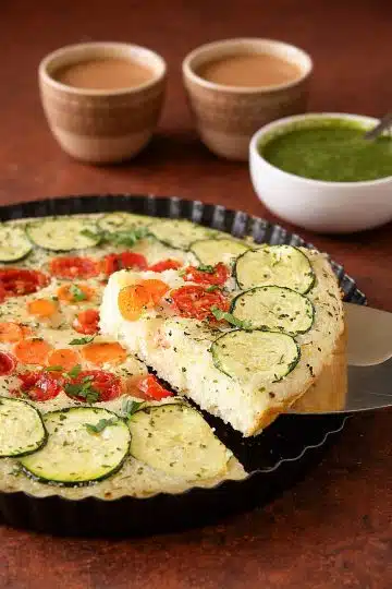 Vegetable semolina quiche with zucchini, tomatoes, carrots, and onions