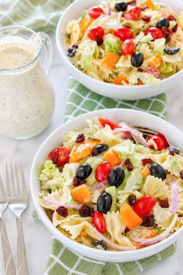 Cranberry Bowtie Pasta Salad in a bowl with dressing on the side