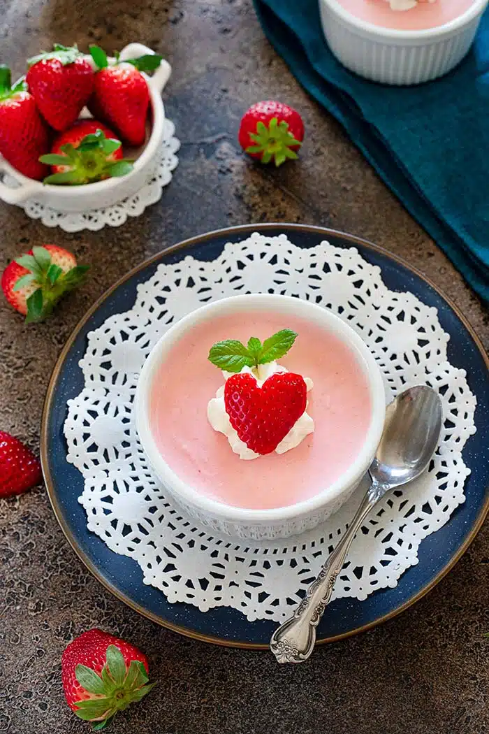 Eggless Strawberry Mousse on a blue plate laced with a dolly
