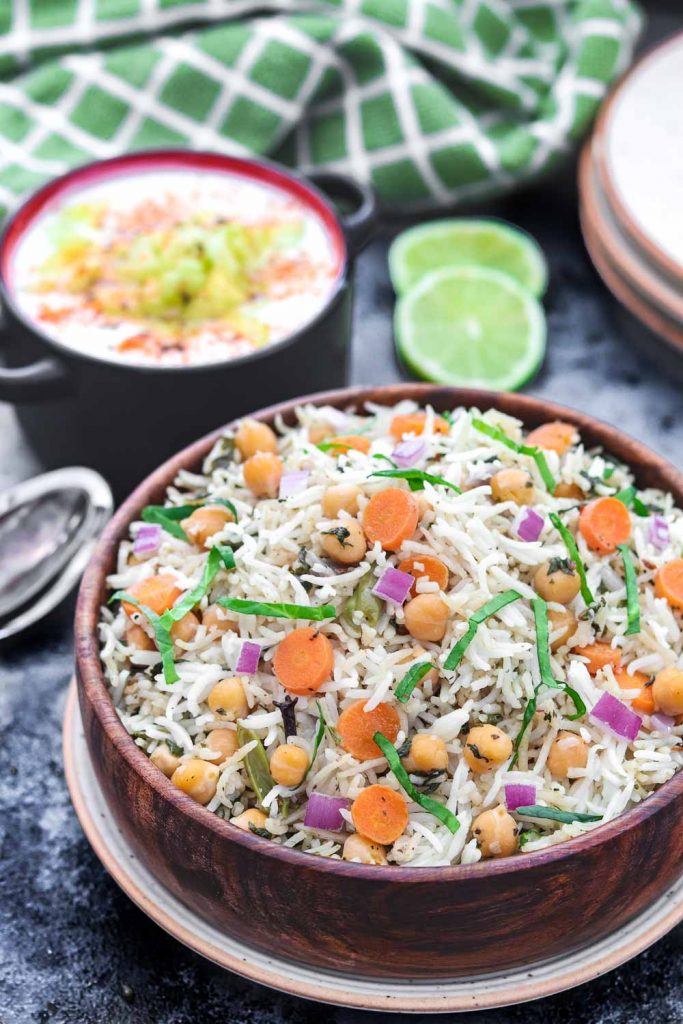 Half cut side view of Instant Pot Chickpea and spinach Pulao - Ruchiskitchen