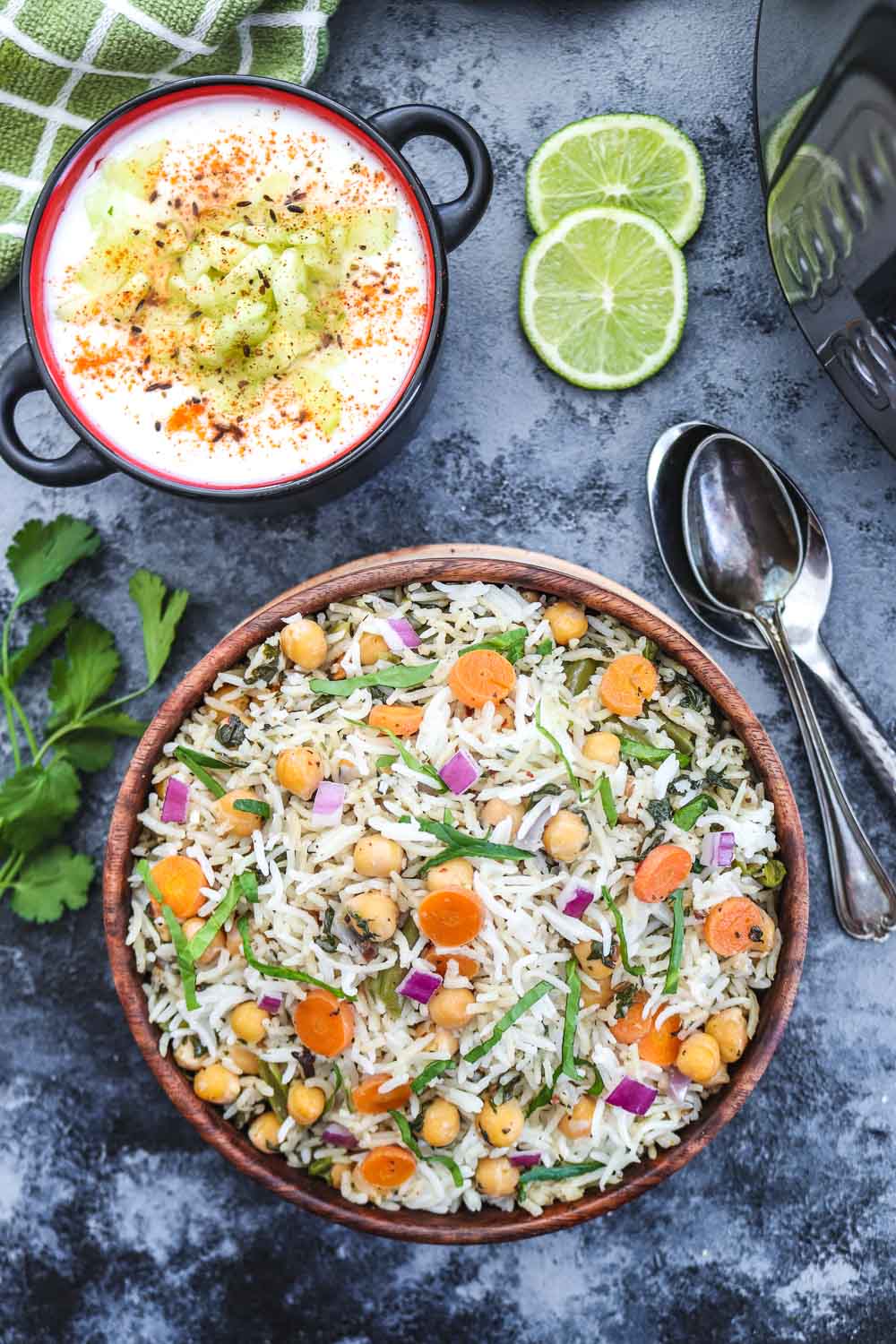 Instant Pot Chickpea and spinach Pulao with raita and two spoons - Ruchiskitchen