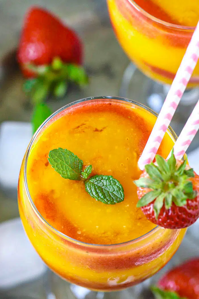 Strawberry Mango daiquiri drink topped with mint leaves