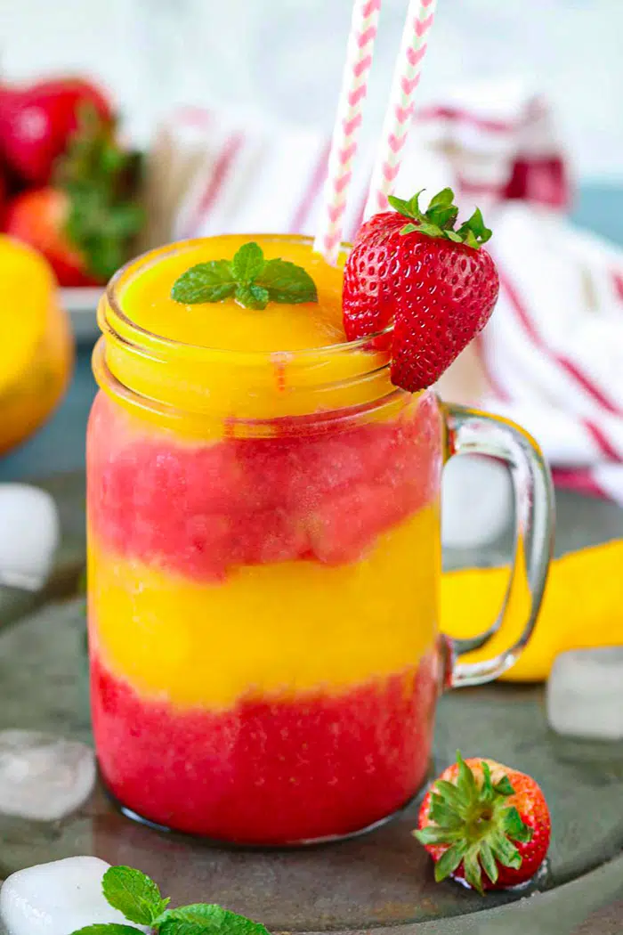 Non Alcoholic Strawberry Mango Daiquiri served in a canning jar with straws