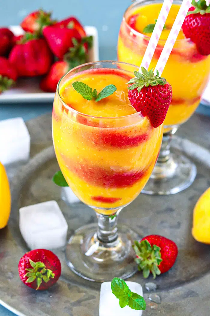 Mango and strawberry daiquiri recipe served with mint leaves