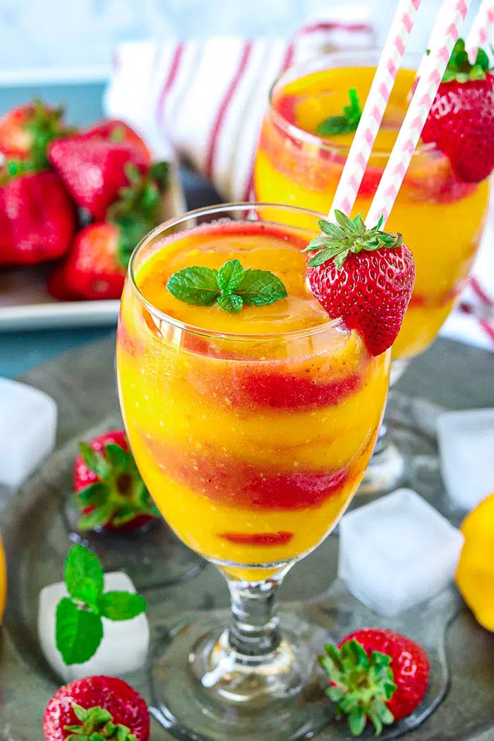 Non Alcoholic Strawberry Mango Daiquiri served in tall glasses with straws