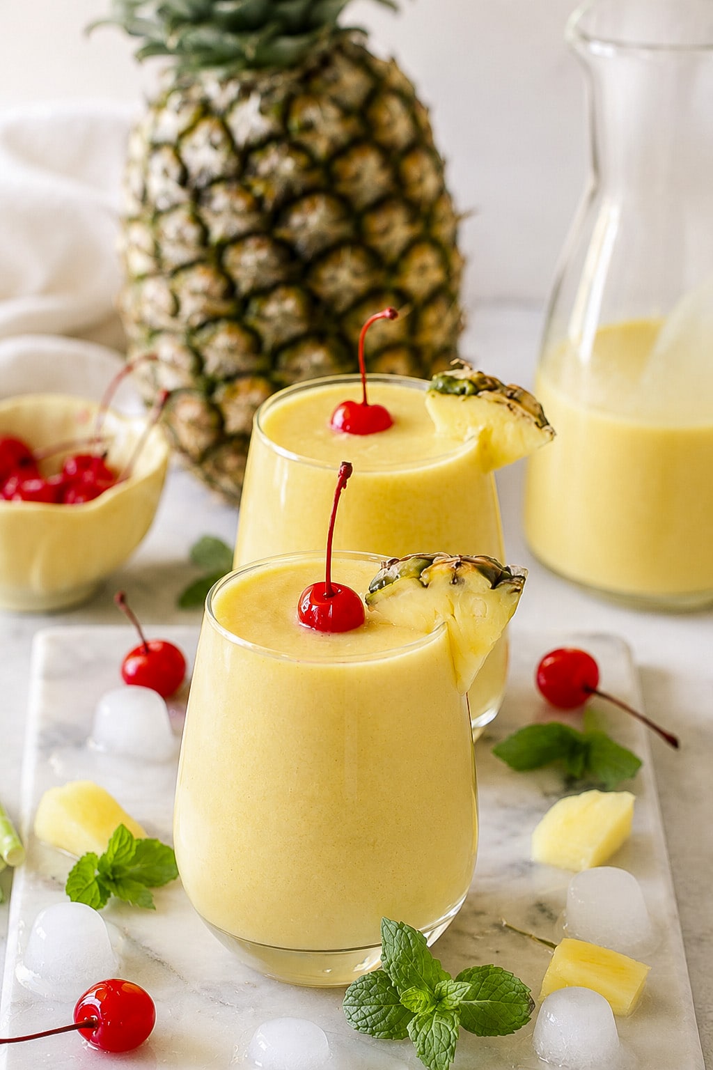 Homemade mango pineapple coconut mocktail with creamy texture and tropical fruit garnish