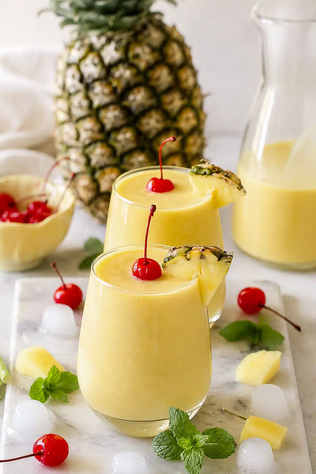 Homemade mango pineapple coconut mocktail with creamy texture and tropical fruit garnish