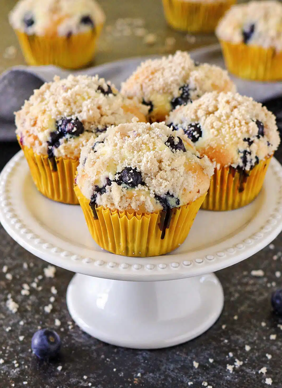 Bakery style blueberry muffins with buttery crumb topping served for breakfast
