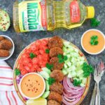 Falafel Salad with full view of Rainbow Salad and props