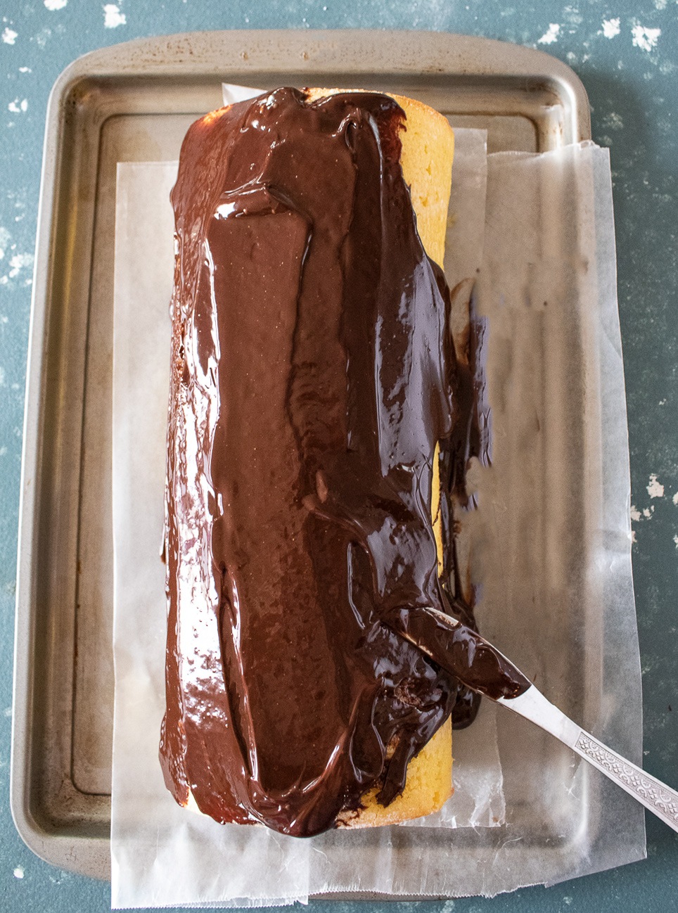 Apply Chocolate Ganache on log cake