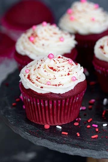Eggless red velvet cupcakes garnished with sprinkles