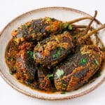 Bharwa Baingan cooked in tomato coconut masala