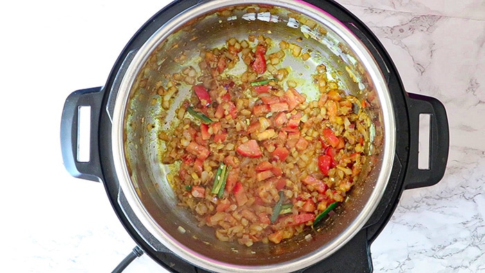 Cook tomatoes with onions