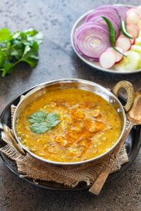 Instant Pot Panchmel dal with rice and onions in a bowl
