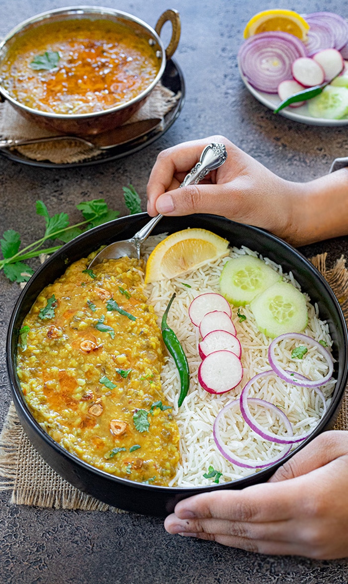 Enjoy Panchmel dal with rice and cucumbers