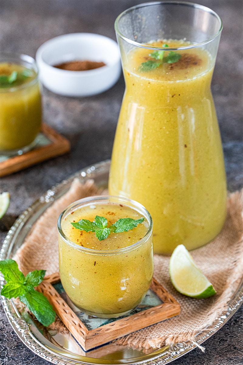 a jug filled with Tangy mango summer coolant panna