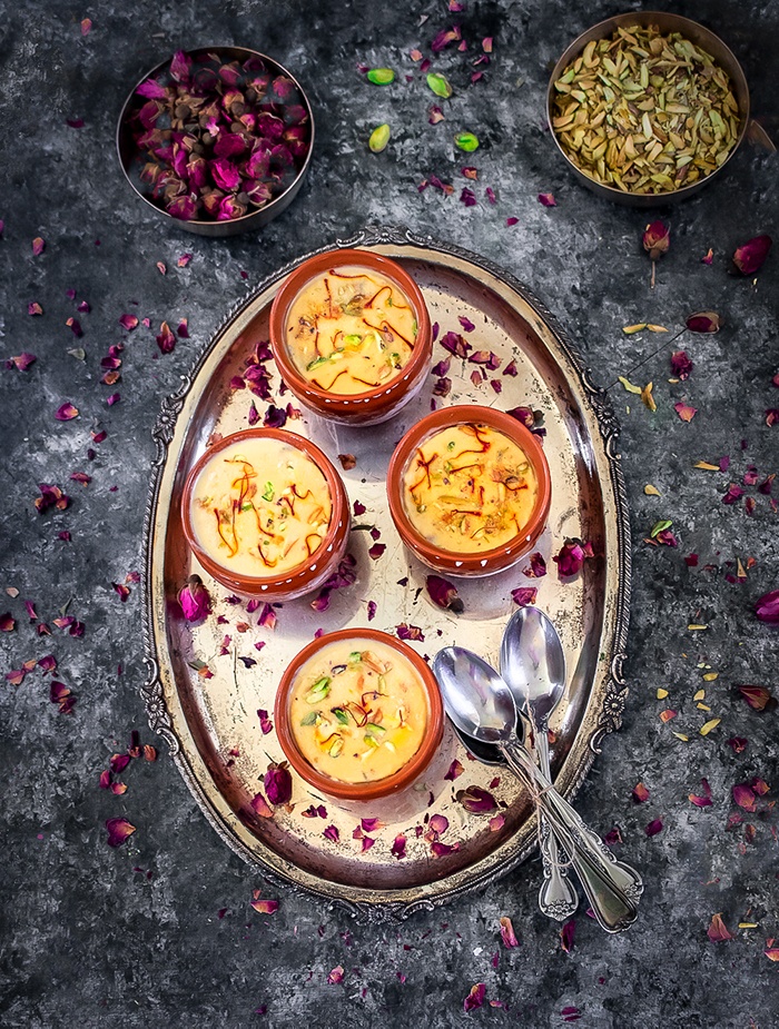 Mango Ice cream on tray with spoons and rose buds