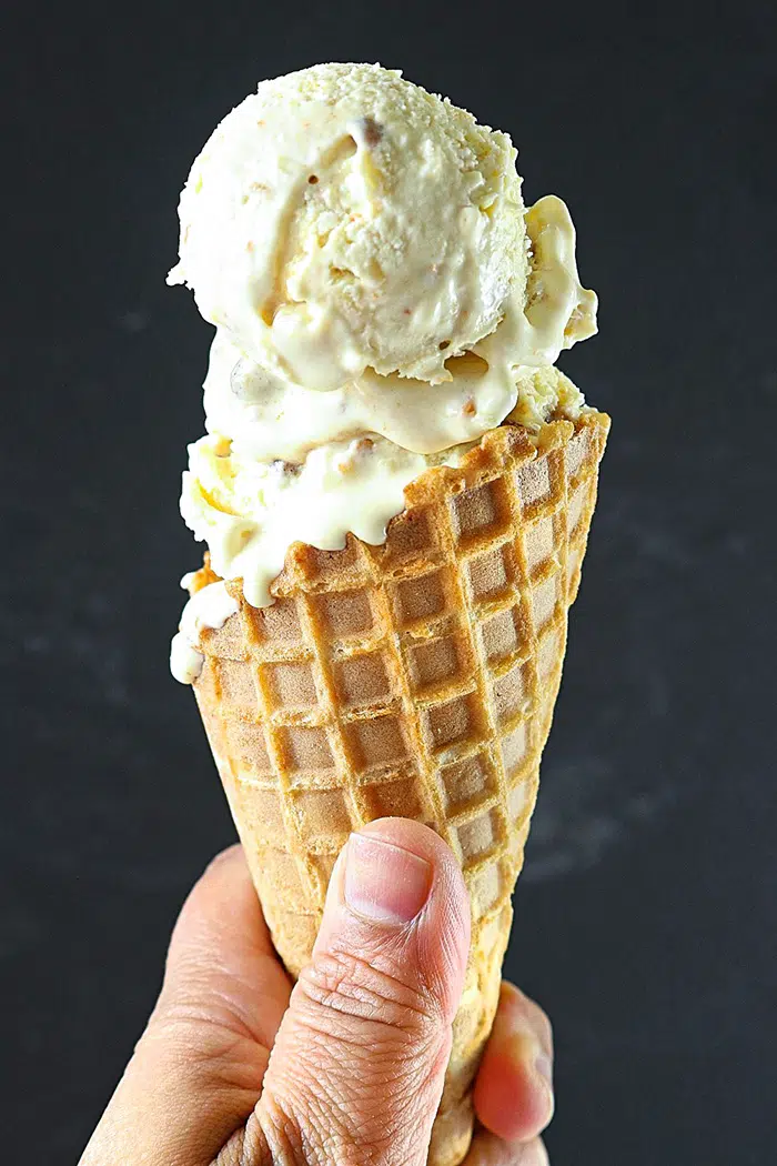 Eggless Butterscotch Ice Cream in a cone in hand