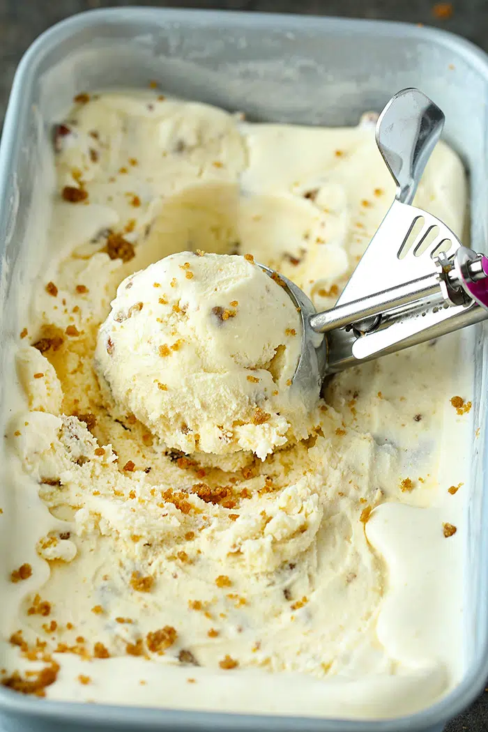Eggless Butterscotch Ice cream scoop in a tub