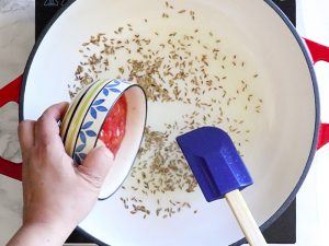 Cook cumin seeds and tomato paste in the pan