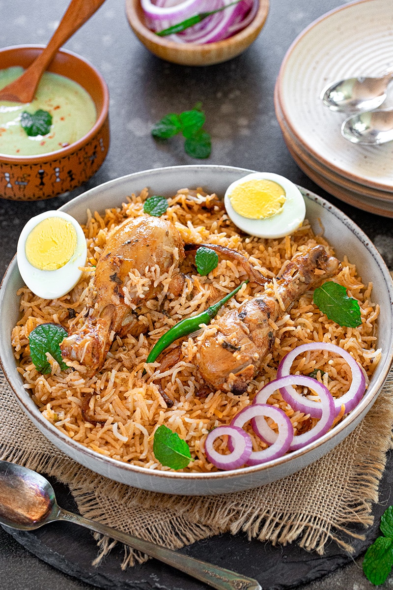 Cooked rice garnished with mint leaves and cilantro